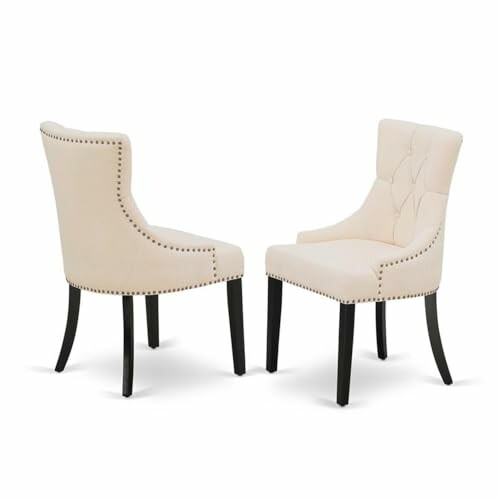 Two beige upholstered dining chairs with dark legs.