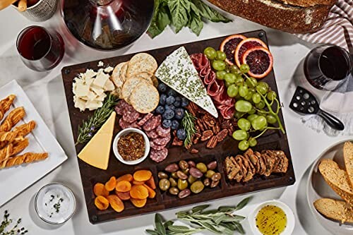 Charcuterie board with cheese, fruits, nuts, and meats.