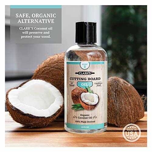 CLARK'S organic coconut oil for cutting boards with coconuts in the background.