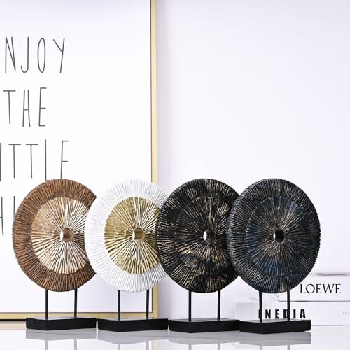 Four decorative stone sculptures with text art in the background