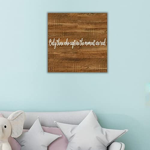 Decorative wooden wall art with quote above sofa and pillows