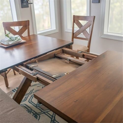 Extendable wooden dining table with chairs in a bright room.