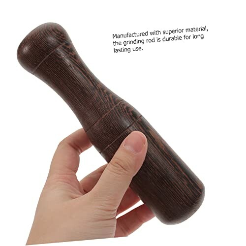 Hand holding a wooden grinding rod with text about durability.