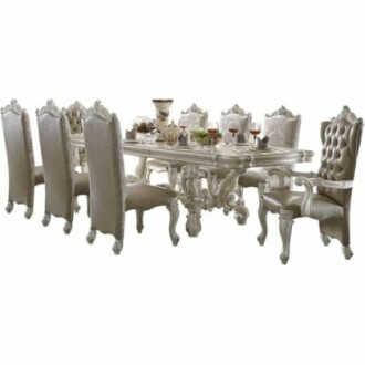 Elegant dining room set with ornate chairs and table, featuring decorative items.