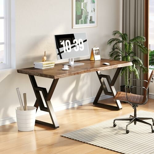 Modern office desk with computer, chair, and plant.