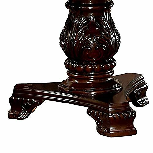 Ornate dark wooden table leg with intricate carvings