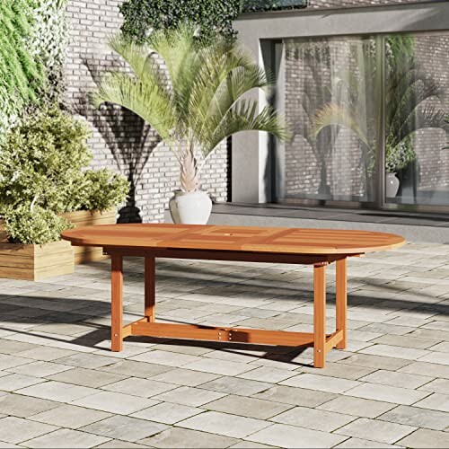 Wooden outdoor table on a patio with plants