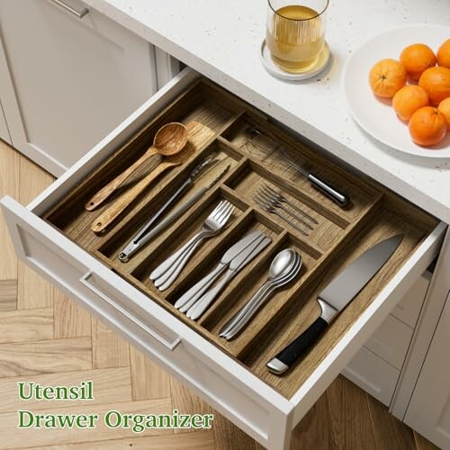 Open kitchen drawer with organized utensils and a knife