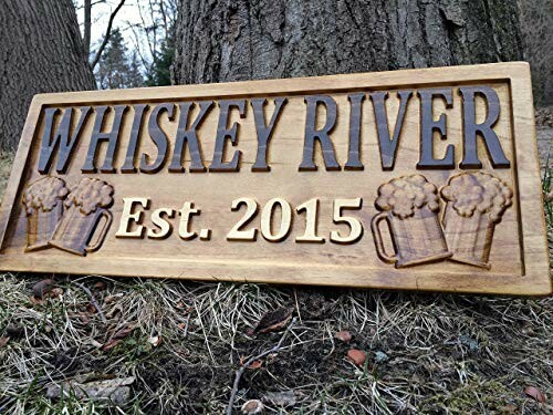 Wooden sign for Whiskey River, established 2015.