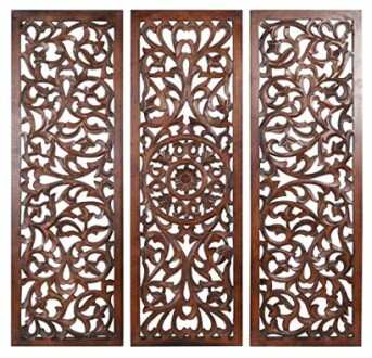 Three intricately carved wooden wall panels with floral designs.