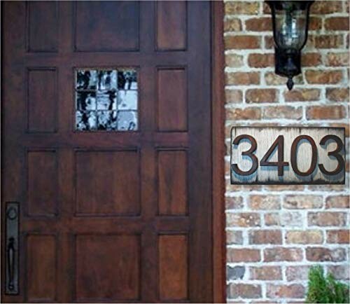 Wooden door with house number 3403 and brick wall.