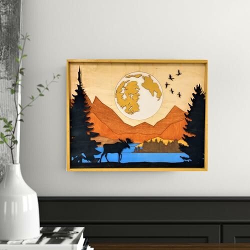 Framed woodland scene with mountains and moon in layered wood art.